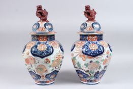 A PAIR OF IMARI FOO DOG VASES. 15ins high.