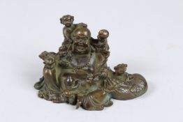 A SMALL BRONZE BUDDHA GROUP. 4ins long.