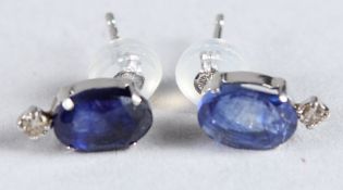 A PAIR OF PLATINUM STUDS set with oval sapphires and RBC diamonds with platinum silicon-capped