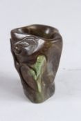 A CARVED STONE VASE carved with a parrot. 4ins high.