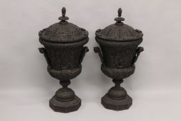 A LARGE PAIR OF WOODEN URNS AND COVERS. 3ft high.