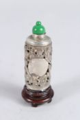 A CHINESE SILVER DRAGON DECORATED SCENT BOTTLE and wooden stand. 2.5ins.