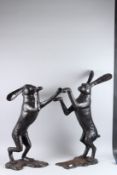 A LARGE PAIR OF BRONZE BOXING HARES. 33ins high.