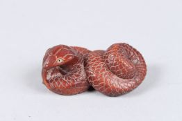 A WOODEN SNAKE NETSUKE. Signed. 2ins long.