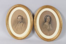 19TH CENTURY SCHOOL pair of head and shoulder portraits of a man and woman, charcoal and chalk, oval