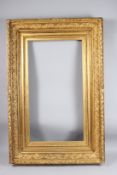 FINE GILTWOOD AND GESSO RECTANGULAR PICTURE FRAME with ornate foliate decoration, rebate size 87.5 x