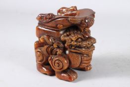 A GOOD CHINESE CARVED HORN DRAGON LIBATION CUP. 5ins high.