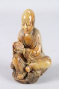 A CHINESE SOAPSTONE LUOHAN FIGURE.