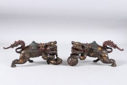 A PAIR OF GILT BRONZE LIONS.