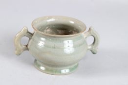 A CHINESE CELADON GLAZED TWIN HANDLED CENSER. 14.5cms from handle to handle.