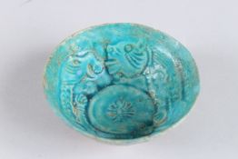 A FINE 12TH - 13TH CENTURY PERSIAN SELJUK KASHAN TURQUOISE GLAZED POTTERY BOWL with two lions. 4.
