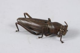 A JAPANESE OKIMONO BRONZE GRASSHOPPER with articulated wing and leg.