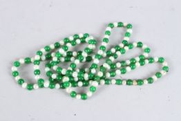 A LONG STRING OF JADE AND PEARL BEADS. 46ins long.