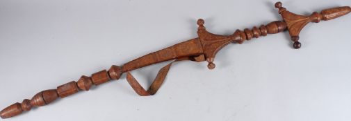 AN UNUSUAL LARGE AFRICAN SWORD with engraved copper blade, the embossed leather handle and