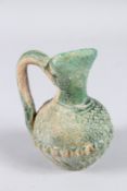 A RARE 8TH - 9TH CENTURY UMAYYAD GREEN GLAZED POTTERY JUG. 5ins high.