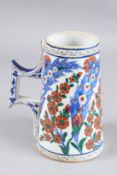 AN OTTOMAN TURKISH IZNIK TANKARD 7.5ins high.