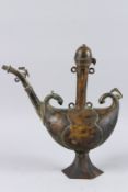 AN UNSUAL INDIAN BOAT SHAPED BRASS EWER. 15ins high.