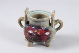 A CHINESE JUN TYPE TRIPLE FOOT CENSER. 9cms high.