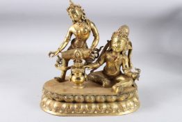 A GOOD CHINESE GILDED BRONZE FIGURE GROUP, one standing playing a drum, the other seated, inset with