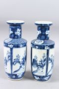 A PAIR OF 19TH CENTURY CHINESE BLUE AND WHITE VASES with panels of figures. Four-character mark in