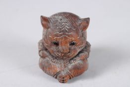 A CARVED WOOD CAT.