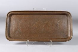 A 19TH CENTURY PERSIAN QAJAR ENGRAVED BRASS TRAY. 22ins x 10ins.
