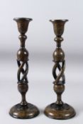 A PAIR OF 19TH OR EARLY 20TH CENTURY ANGLO INDIAN KASHMIRI LACQUERED PAPIER MACHE CANDLESTICKS.