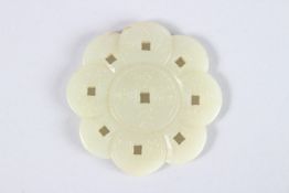 A SMALL CHINESE CARVED JADE BI DISC in the form of coins. 2ins diameter.