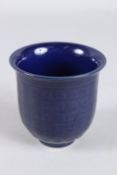 A CHINESE POWDER BLUE BELL SHAPED CUP bearing six-character mark. 9cms high.