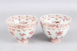 A PAIR OF CHINESE UNDERGLAZED RED BOWLS. 12cms diameter.