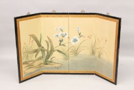 AN EARLY 20TH CENTURY JAPANESE FOUR PANEL FOLDING SCREEN, painted with flowers by a pond. Overall