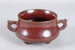 A CHINESE BOWN GLAZED TWO HANDLED CIRCULAR BOWL. Imperial mark. 4.25ins diameter.