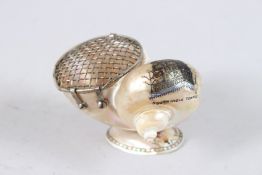 A 19TH CENTURY INDIAN SHELL with a carved scene of a south Indian temple, and white metal lid. 4.