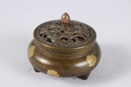 A SMALL CHINESE GOLD SPLASH CIRCULAR CENSER AND COVER on three short legs. 3.5ins diameter.