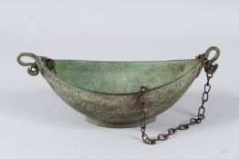 A 19TH CENTURY CENTRAL ASIAN BUKHARA ENGRAVED KASHKUL BOWL. 8.5ins long.