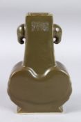 A CHINESE BROWN VASE with elephant handles, six-character mark in blue. 9.5ins high.