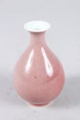A MINIATURE CHINESE RED GLAZED YUHUCHUN VASE. 10.5cms high.