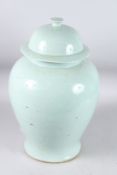 A LARGE 18TH CENTURY CELADON TEMPLE JAR AND COVER. 20ins high.