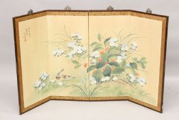 AN EARLY 20TH CENTURY JAPANESE FOUR PANEL FOLDING SCREEN, painted with birds amongst flowers.