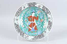 A TURKISH OTTOMAN IZNIK PLATE portrait of a man. 12ins diameter.