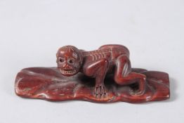 A CARVED WOOD SKELETON FIGURE. Signed. 4ins high.