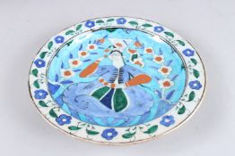 A 19TH CENTURY OTTOMAN TURKISH ISNIK PLATE decorated with a figure 12ins diameter.