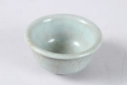 A CHINESE GUAN TYPE WINE CUP. 8.5cms diameter.