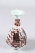 A CHINESE UNDERGLAZED RED YUHUCHUN SHAPED VASE. 14cms high.