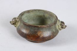 A SMALL CHINESE BRONZE CIRCULAR CENSER with lion mask handles. 2.75ins diameter.
