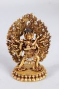 A GILT BRONZE TIBETAN KALACHAKRA STATUE.