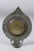 A FINE 18TH CENTURY TIBETAN OR NEPALESE BRONZE MIRROR. 11ins high.