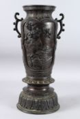 A LARGE CHINESE BRONZE TWO-HANDLED VASE with panels of flowers and foliage. 19ins high.