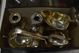 A group of silver items to include sauce boats, spoons and a pair of candlesticks.