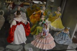 A group of seven Royal Doulton porcelain figurines.